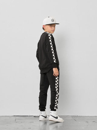 Little Bipsy Stripe Checkered Pullover - Black
Child wearing a black checkered outfit with a white cap on a light gray background