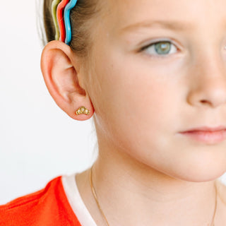 Pierced Co. Crown Earrings
Close-up of a child wearing a gold earring with a white background