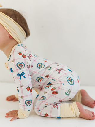 In My Jammers Zipper Romper - Sweet Plaid
Baby wearing a colorful outfit with patterns on a white background