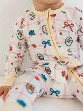 In My Jammers Zipper Romper - Sweet Plaid
Baby wearing a colorful outfit with patterns on a plain background