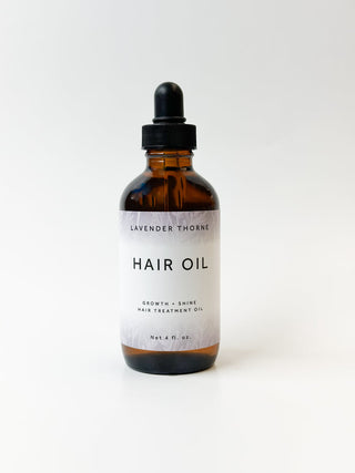 Lavender Thorne Hair Serum in a clear bottle with a pump dispenser, featuring a lavender and white label, on a white background.