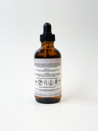 Lavender Thorne Hair Serum in a clear glass bottle with dropper, designed for nourishing and styling hair with lavender scent.