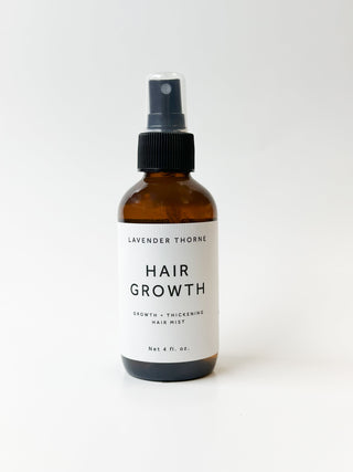 Lavender Thorne Hair Growth Serum bottle with dropper, showcasing the product for healthy hair enhancement.