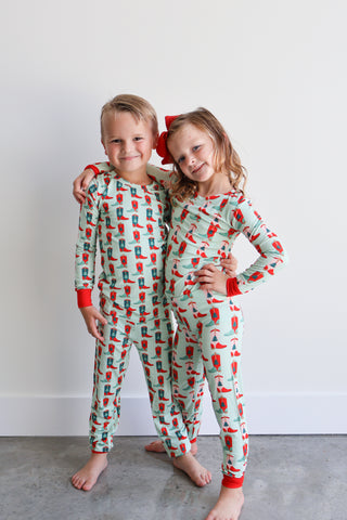 Hollis Baker pink loungewear pajama set with holiday-themed boots, featuring cozy fabric and playful design.