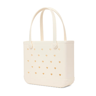 In Love BABY BOGG BAG Coconut
Beige tote bag with gold heart patterns on a white background