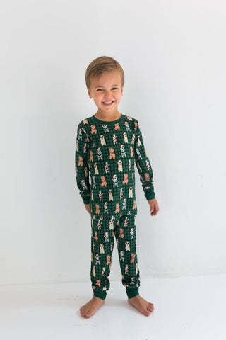 In My Jammers Christmas Pups Two Piece Set
Child wearing green pajamas with a pattern on a white background