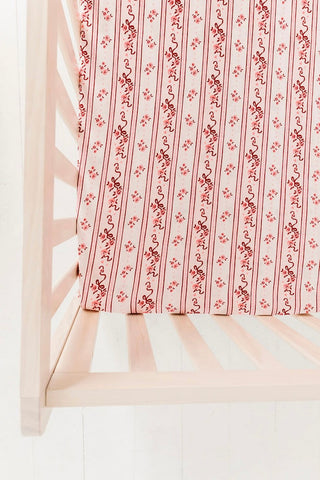 In My Jammers Crib Sheet - Vintage Love
Floral-patterned fabric draped over a white chair