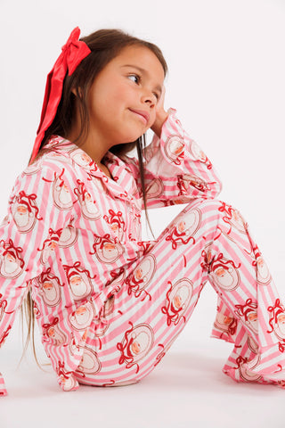In My Jammers girl's pink ruffle flare pajama set with Santa Claus lane print, cozy two-piece Christmas sleepwear for girls.