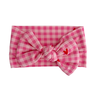 In My Jammers Headband - Be Mine Gingham

Pink gingham headband with a small red heart on a white background