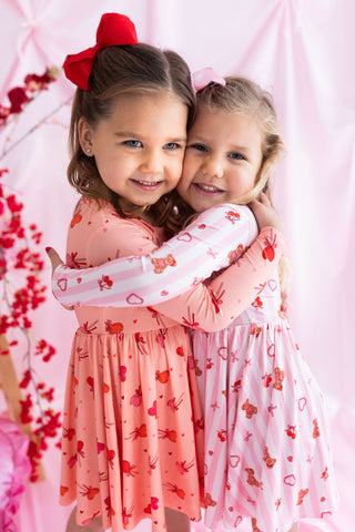 In My Jammers Long Sleeve Twirl Dress - Love You Bear-y Much
Two young girls in matching dresses with a floral background