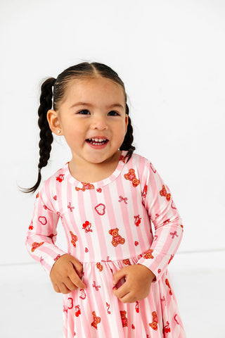 In My Jammers Long Sleeve Twirl Dress - Love You Bear-y Much
Child wearing a pink dress with teddy bear pattern against a white background
