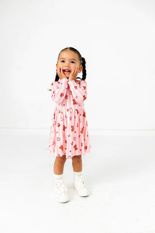 In My Jammers Long Sleeve Twirl Dress - Love You Bear-y Much
Child wearing a pink dress with a pattern on a white background