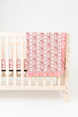 In My Jammers Ruffle Blanket - Vintage Love
Crib with pink and red floral crib sheet on a white background
