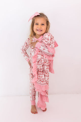 In My Jammers Ruffle Blanket - Vintage Love
Young girl wearing a pink and white patterned outfit with ruffles on a white background