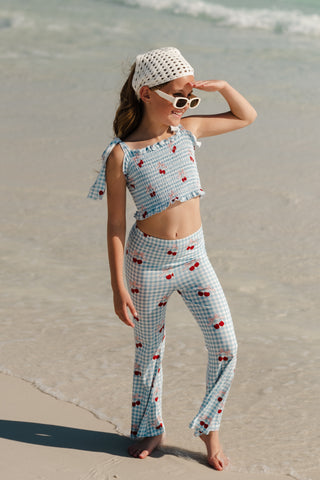 In My Jammers Smocked Flare Set for kids, featuring a pink top with smocking and matching flare pants with Little Cherry print.