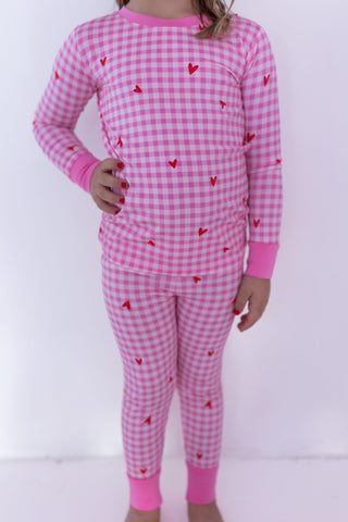 In My Jammers Two Piece Set - Be Mine Gingham
Pink gingham pajama set with red heart patterns on a white background