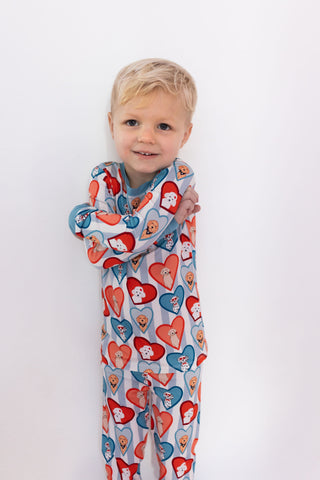 In My Jammers Two Piece Set - Blue Fur-Ever Valentine
Child wearing a colorful onesie with heart patterns on a white background