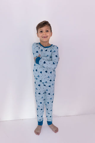 In My Jammers Two Piece Set - Blue Sugar Rush
Child wearing a blue heart-patterned pajama set on a white background