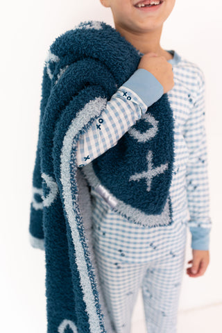 In My Jammers Two Piece Set - Blue XO Gingham
Child wearing a blue and white patterned robe with a matching outfit on a white background