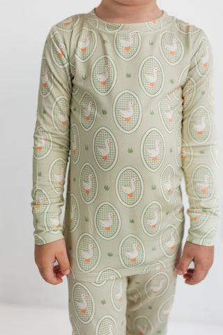 In My Jammers Two Piece Set - Green Little Goose
Child wearing a green pajama set with a pattern of birds and circles on a white background