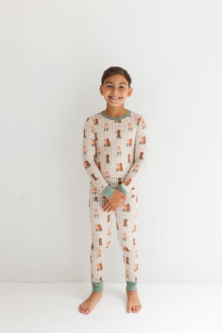 In My Jammers Two Piece Set - Green Pup Friends
Child wearing a patterned onesie on a white background