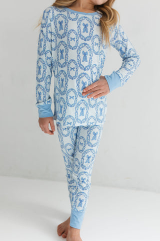 In My Jammers Two Piece Set - Julia Bow
Child wearing blue and white patterned pajamas on a plain background
