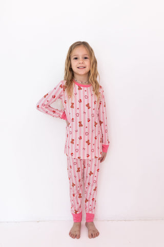 In My Jammers Two Piece Set - Love You Bear-y Much
Young girl wearing pink pajamas with teddy bear pattern on a white background