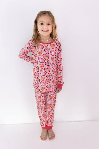 In My Jammers Two Piece Set - Pink Fur-Ever Valentine
Child wearing a pink heart-patterned onesie on a white background