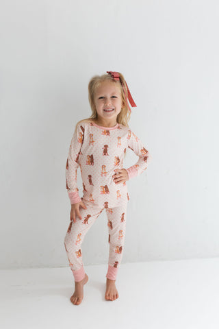In My Jammers Two Piece Set - Pink Pup Friends
Child wearing a pink pajama set with animal print on a white background