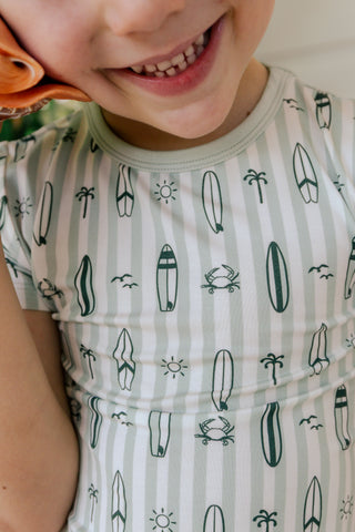 In My Jammers green two-piece pajama set with surf-themed design, featuring a short-sleeve top and matching shorts.