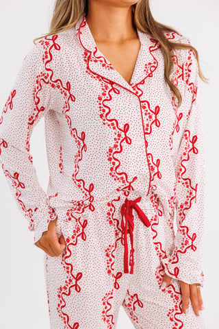 In My Jammers women's long sleeve ruffle pajama set with vintage bows and blossom patterns, shown with button-up top and matching pants.