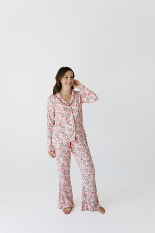 In My Jammers Women's Long Sleeve Ruffle Set - Mistletoe Bows
A woman modeling a two-piece long-sleeve pajama set with a red and green floral print on a white background, standing against a plain white studio backdrop.