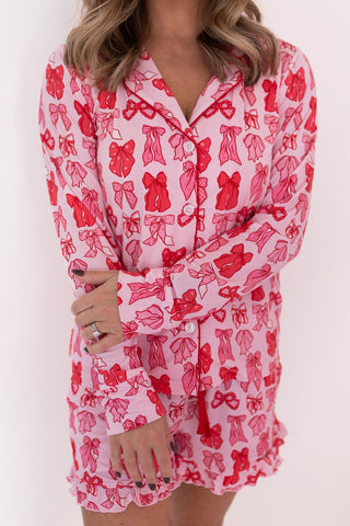 In My Jammers Women's Long Sleeve Short Set - Valentine's Bow
Pink pajama set with red bow pattern worn by a person on a white background
