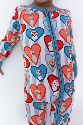 In My Jammers Zipper Romper - Blue Fur-Ever Valentine
Children's onesie with heart and dog pattern on a white background