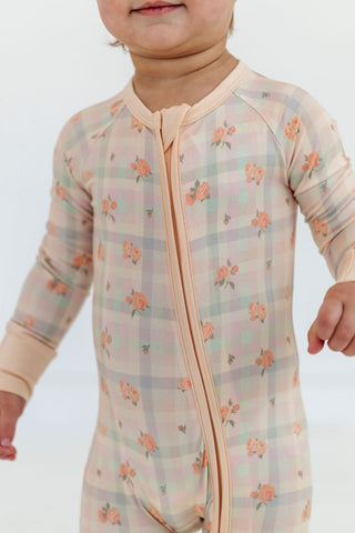 In My Jammers Zipper Romper - Frankie Plaid
Baby wearing a floral patterned onesie with a zipper on a plain background