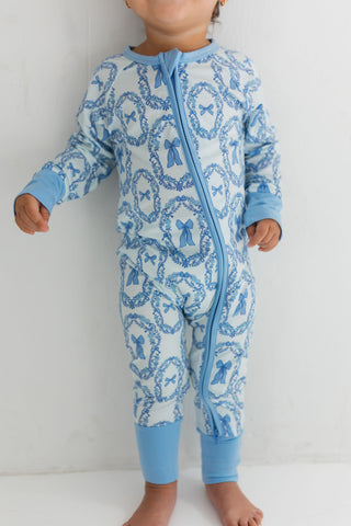 In My Jammers Zipper Romper - Julia Bow
Child wearing a blue and white patterned onesie on a plain background