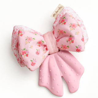 Itzy Ritzy Bow Teensy Crinkle teether with a pink bow design, soft crinkle texture, ideal for soothing teething babies.