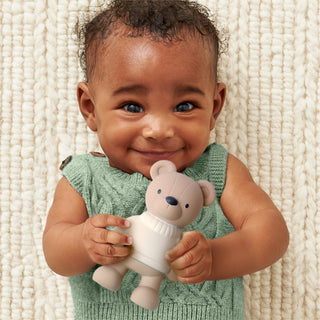 Itzy Ritzy Comfort Crew™ - Bear
Baby holding a teddy bear against a textured beige background