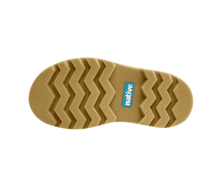 Native Kensington Chelsea Child - Regatta Blue / Gum Brown
The tan outsole of a boot, featuring a zigzag tread pattern and a small blue 'native' brand logo, shown against a solid white background.
