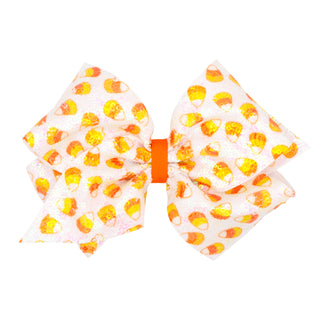 King Wee Ones Candy Corn Sequin Hair Bow on Clippie
A double bow hair accessory featuring a white fabric printed with orange and yellow candy corn motifs, secured with a bright orange center band, shown on a plain white background.