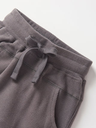 Little Bipsy Ribbed Jogger - Graphite
Gray sweatpants with drawstring on a white background