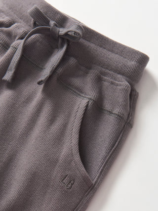 Little Bipsy Ribbed Jogger - Graphite
Gray ribbed knit pants with drawstring on a white background