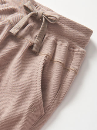 Little Bipsy Ribbed Jogger - Mushroom'
Brown ribbed knit pants with a drawstring on a white background