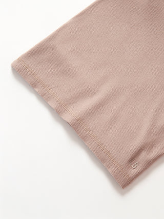 Little Bipsy Long Sleeve Ribbed Tee - Mushroom
Close-up of a beige fabric texture on a white background