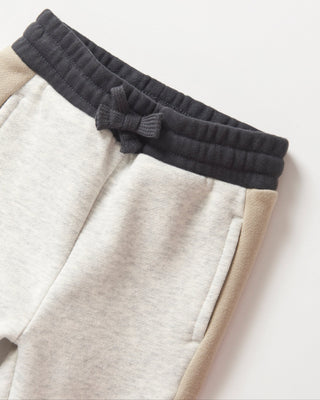 Little Bipsy Side Stripe Jogger - Stone Grey
Close-up of a pair of pants with a black waistband on a light background