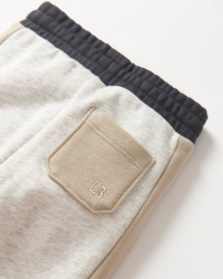 Little Bipsy Side Stripe Jogger - Stone Grey
Close-up of a beige and black pants with a pocket and 'LB' logo on a white background
