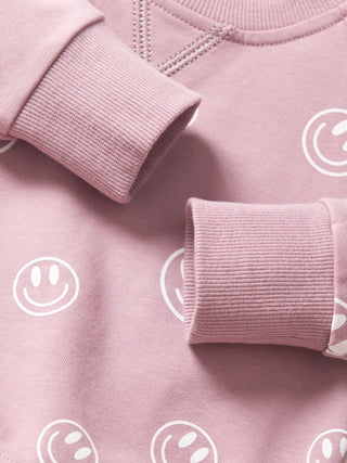 Little Bipsy Smiley Pullover - Dusty Purple
Pink sweatshirt with white smiley face patterns on a matching background