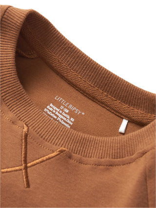 Little Bipsy Pocket Pullover - Chestnut
Close-up of a brown sweater with 'LITTLE BIPSY' label on a light gray background