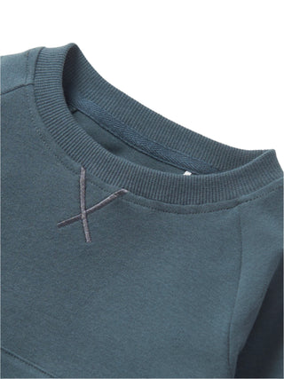 Little Bipsy Pocket Pullover - Night Fall 
Close-up of a blue sweater collar with a brand logo.