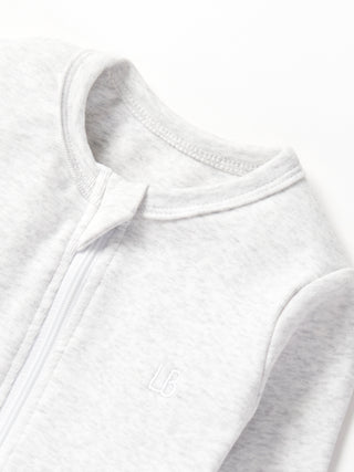 Little Bipsy 2-Way Zip Romper - Light Heather Grey
Close-up of a white fleece jacket collar on a white background